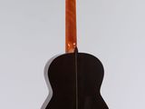 an acoustic guitar hanging on a wall with a white background