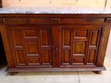 a wooden cabinet with a marble top on a tile floor