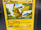 the pokemon card is in a clear box on the table