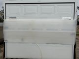 a white refrigerator sitting on a pallet in a yard