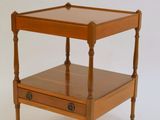 a small wooden table with a drawer underneath it