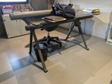a black desk with a laptop on it in a room