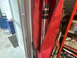 une personne tenant un parapluie rouge dans un garage