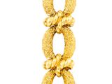 an image of a close up of a gold bracelet with a diamond