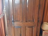 a wooden cabinet with a chain hanging from the top of it