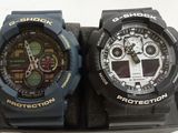 two watches that are sitting on top of a box
