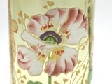 a close up of a vase with a flower painted on it