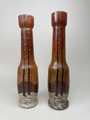 two vases sitting side by side on a white surface
