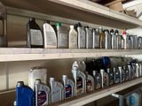 many bottles of motor oil on the shelves in the garage