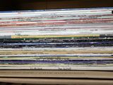 une pile de livres posée sur une étagère d'une bibliothèque