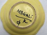 an image of a yellow bowl with a black writing on it