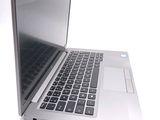 a silver laptop computer sitting on top of a white table