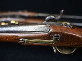 a close up of a rifle on a table with a black background