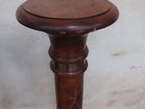 a small wooden table with a wooden top on the sidewalk