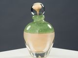 a glass bottle with a liquid inside of it on a table