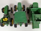 a green toy tractor and a green tractor and a green dump truck