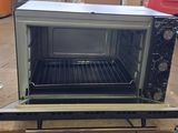 an open oven sitting on top of a pallet in a warehouse