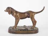 statue of a dog standing on a base on a white background