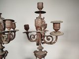 pair of antique candelabs with ornate carvings on each of them