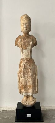 statue of a woman in a dress standing on a black base