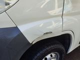 a white van that has a dent in the side of it