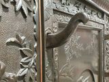 a metal door with a bird on it in a building