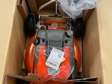 a box with a lawn mower inside of it
