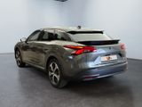 the rear end of a grey car in a showroom