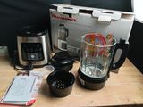 a blender sitting on top of a wooden table next to a box