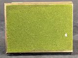 a close up of a small green box on a black surface