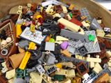 a wooden bowl filled with legos and other toys