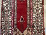 an oriental rug with a man in a hat on it