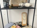 a shelf that has a bunch of jewelry on it