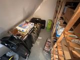 several suitcases are lined up on a shelf in the corner of a room
