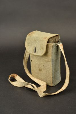 an old camera case with a strap on a black background