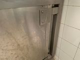 a dirty floor in a kitchen with a sink and dishwasher