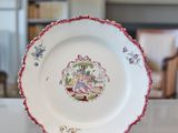 a plate that is sitting on a table in front of a bookshelf