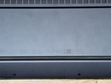 a black laptop sitting on top of a wooden table