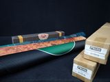 three boxes and a knife on a black surface