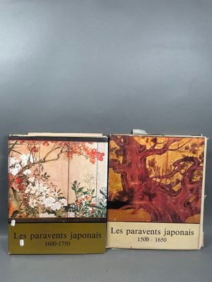 two books on a table with a picture of a tree in the background