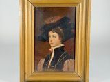 portrait of a young boy in a black hat and a gold frame