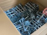 a box with a bunch of screws in it and a person holding a pair of scissors