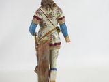 a figurine of a man with a goat on his back