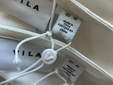 three bags with labels on them sitting on top of a table