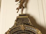 a clock with a statue of an angel on top of it