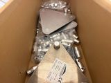 a box full of assorted metal parts in it