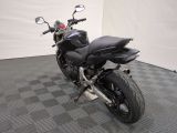 a picture of a black motorcycle parked on a checkered floor