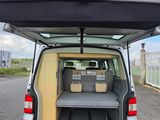 the back of a van with a bed in the back of it
