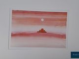 une photo d'une photo représentant un désert avec une pleine lune dans le ciel