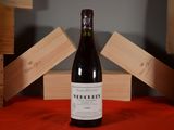 a bottle of wine sitting on a table next to wooden crates